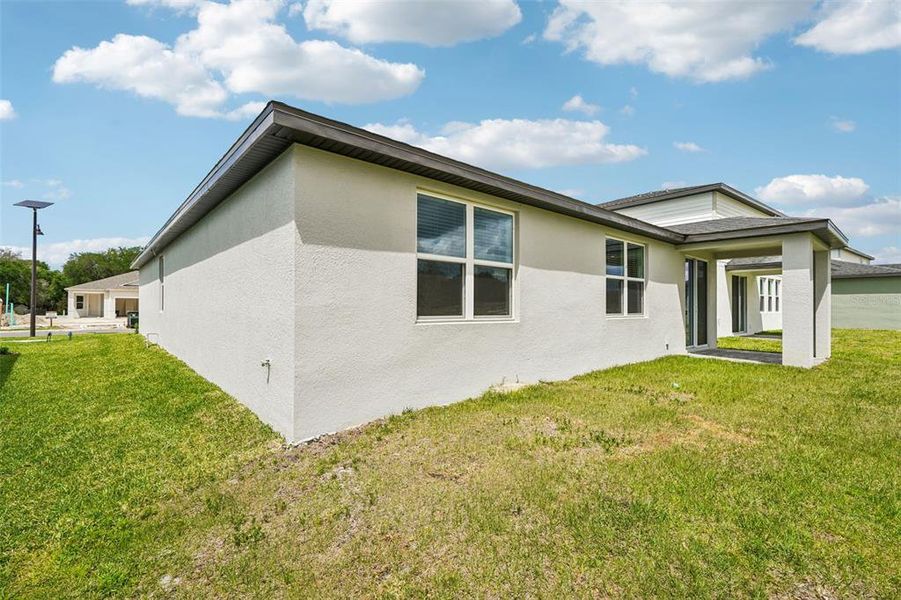 Exterior details and patio area of a home in The Reserve at Hammock Oaks - Signature Series, Lady Lake (Image 22).