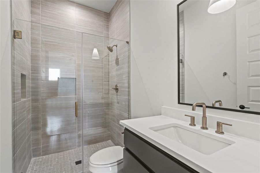 Full bath featuring vanity and a stall shower Full bath featuring vanity and a stall shower