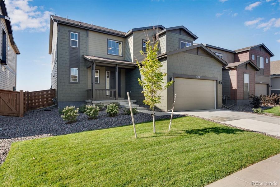Front exterior of a new home in Reunion Ridge, Commerce City, CO, highlighting curb appeal (Image 21).