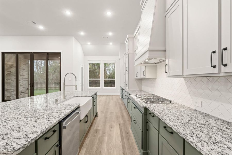 SS GE built in appliances, tile backsplash and modern lighting