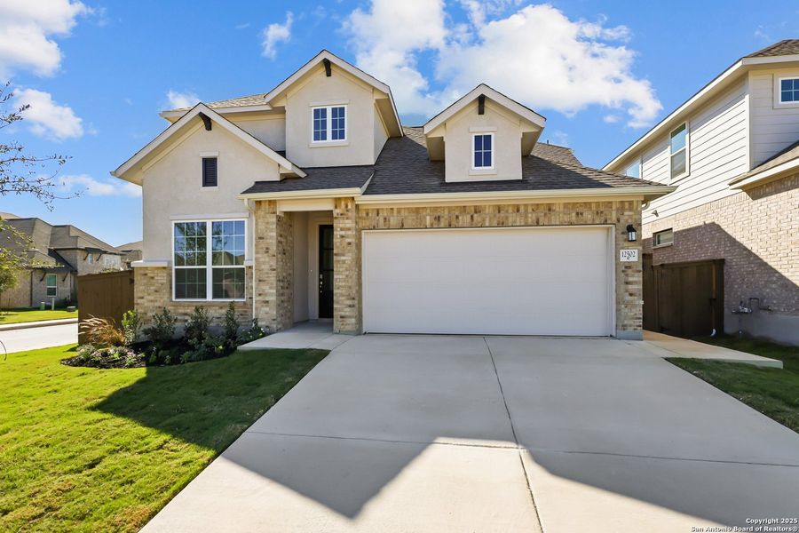 Front exterior of a new home in Stillwater Ranch, San Antonio, TX, highlighting curb appeal (Image 21). Front exterior of a new home in Stillwater Ranch, San Antonio, TX, highlighting curb appeal (Image 21).