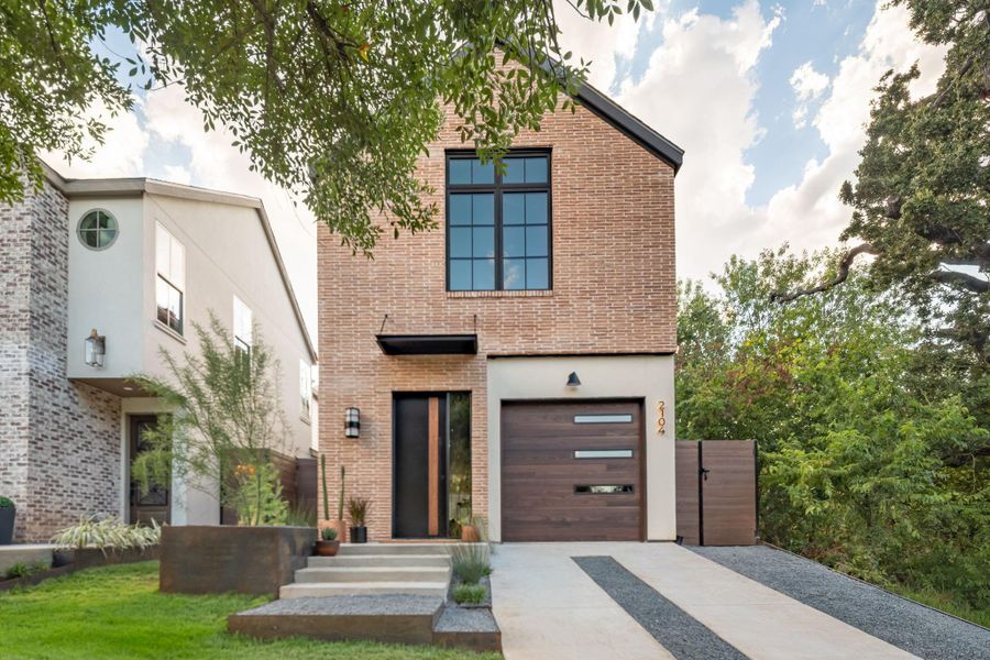 Modern brick and wood elements create striking curb appeal in this contemporary design. Modern brick and wood elements create striking curb appeal in this contemporary design.