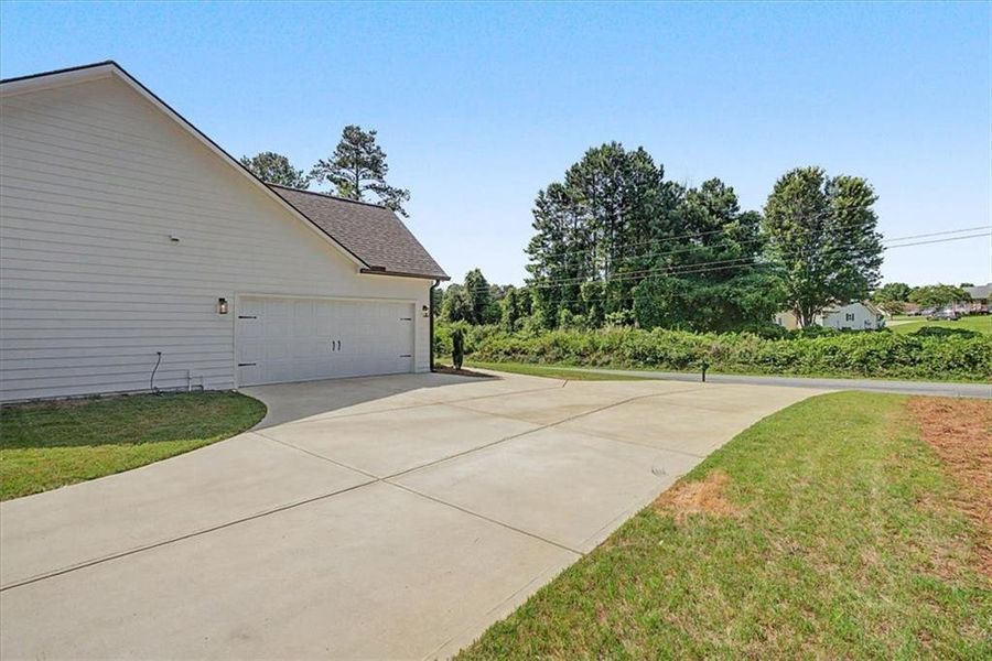 Front exterior of a new home in , Dallas, GA, highlighting curb appeal (Image 21).