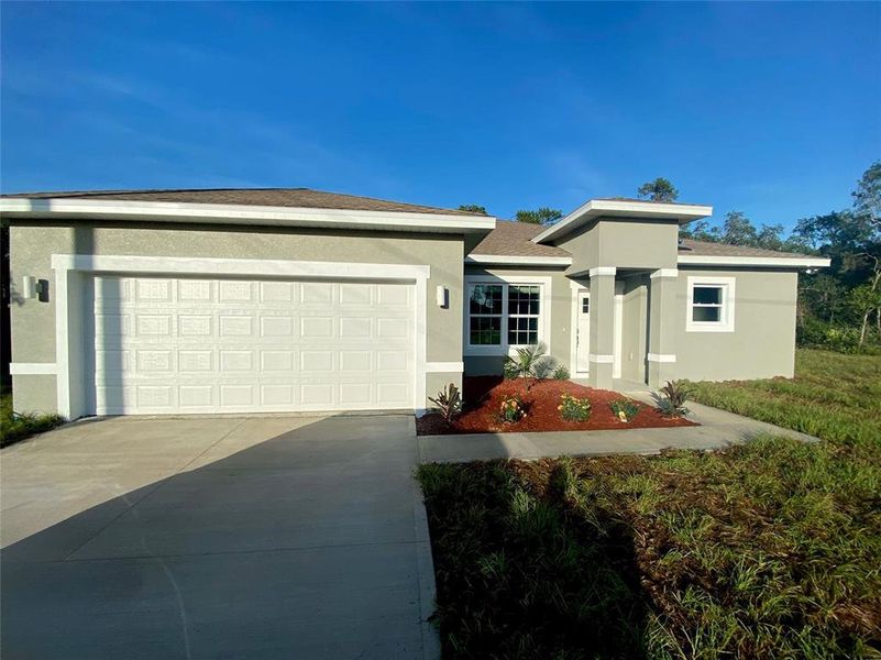 Front exterior of a new home in , Citrus Springs, FL, highlighting curb appeal (Image 1).