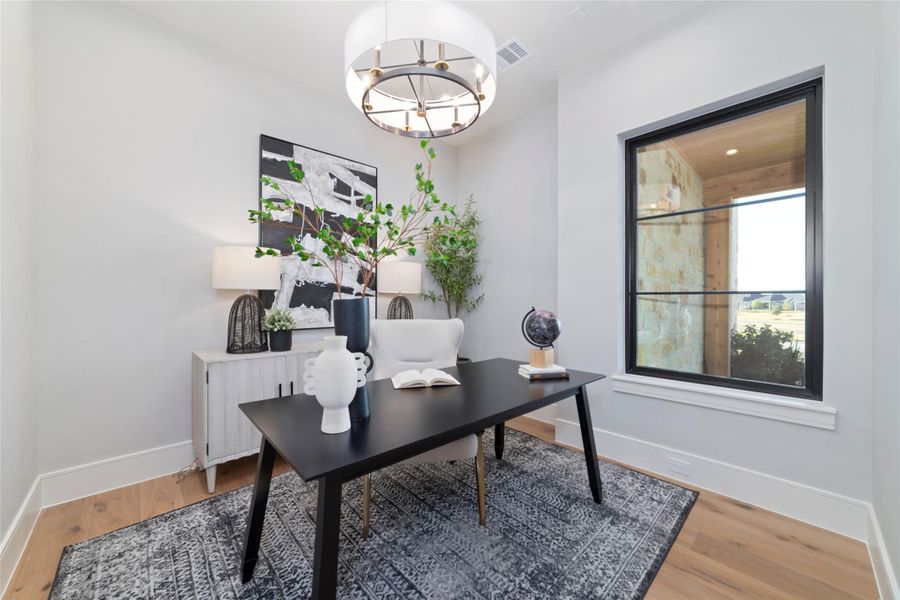 Private home office with large windows with views of the front yard.