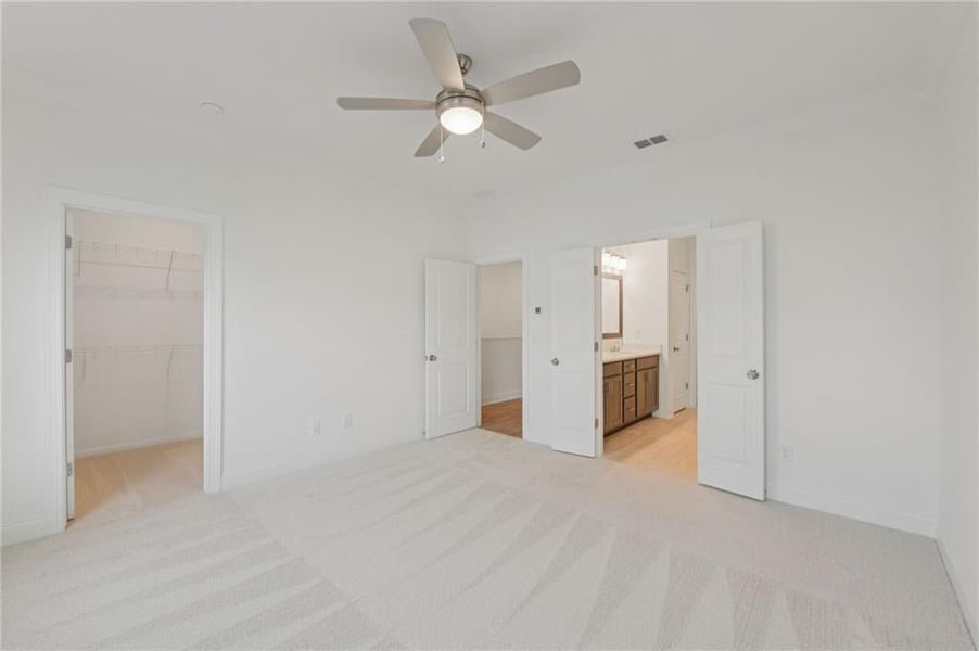 primary bedroom with ensuite bathroom and closet
