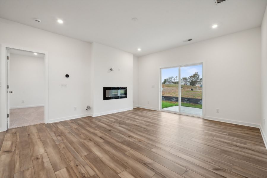 A room with a wood floor and a wood floor with a window. A room with a wood floor and a wood floor with a window.
