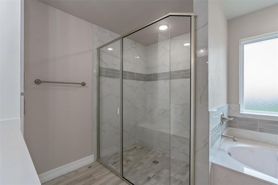 Corner glass-enclosed shower with tile surround and built-in bench Corner glass-enclosed shower with tile surround and built-in bench