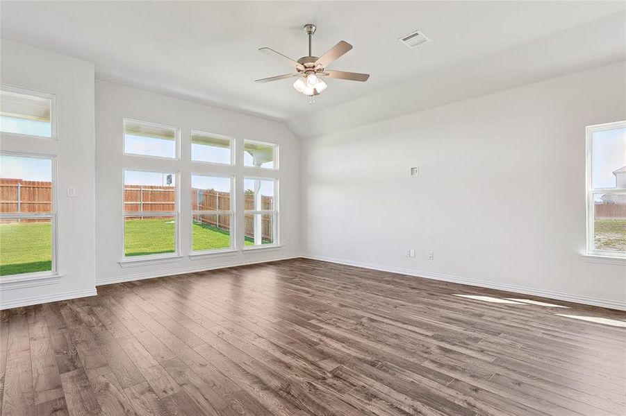 Unfurnished room with hardwood / wood-style flooring and ceiling fan