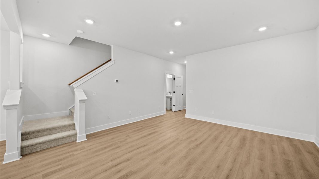 Elegant family room with hardwood flooring and open-concept flow in this first-class DRB Homes design