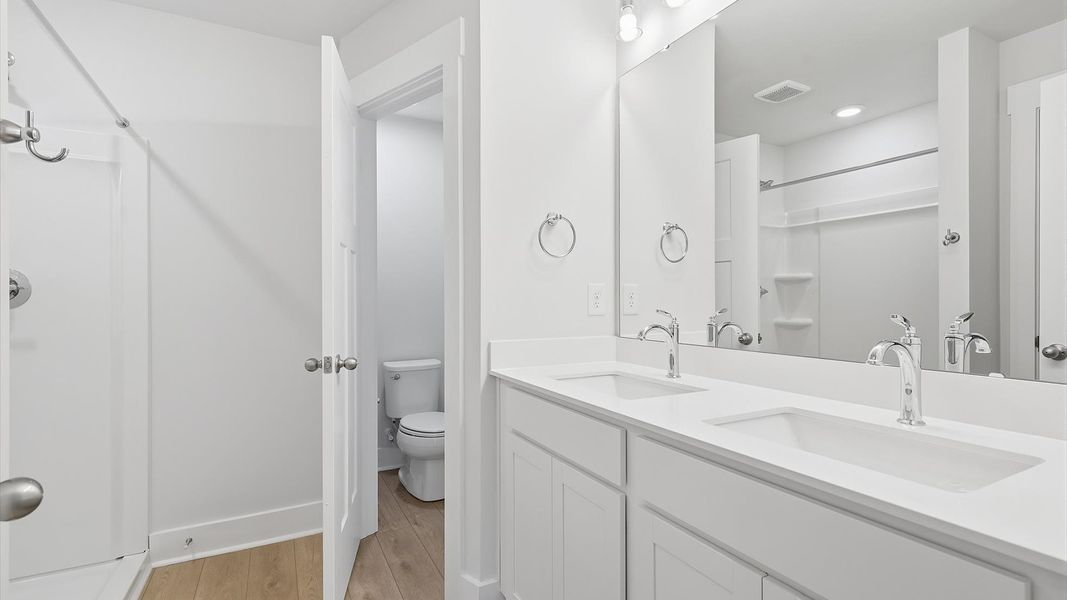 Notable primary suite with dual vanities and walk-in shower in this prime Lyman villa Notable primary suite with dual vanities and walk-in shower in this prime Lyman villa