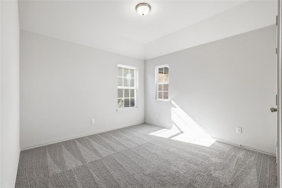 Empty room with carpet floors and baseboards