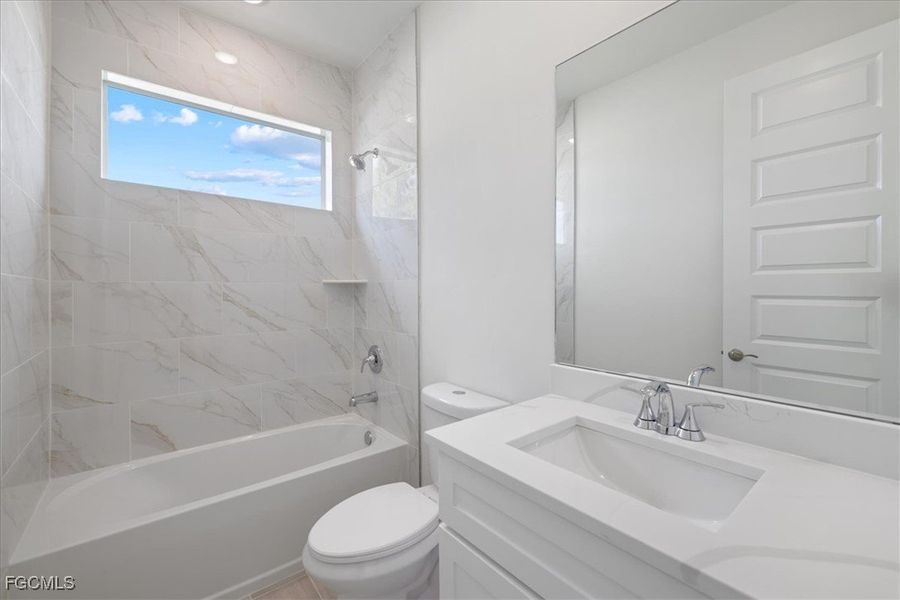 Full bath featuring vanity and shower / bath combination