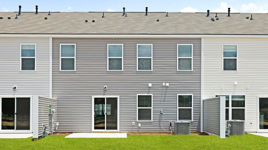 Front exterior of a new home in Pine Hills Townhomes at Cane Bay, Summerville, SC, highlighting curb appeal (Image 14). Front exterior of a new home in Pine Hills Townhomes at Cane Bay, Summerville, SC, highlighting curb appeal (Image 14).