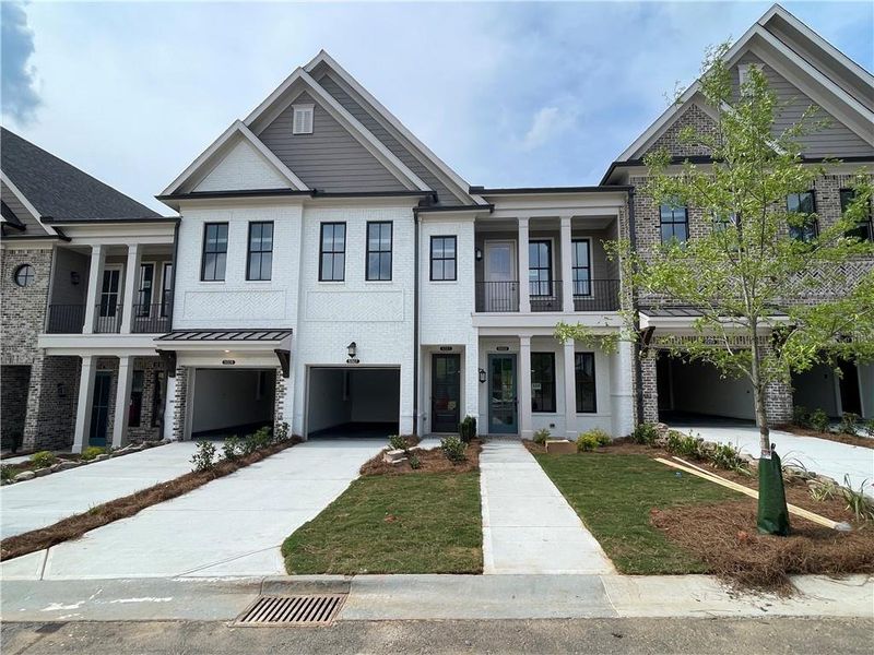 Front exterior of a new home in Waterside Condos, Peachtree Corners, GA, highlighting curb appeal (Image 18). Front exterior of a new home in Waterside Condos, Peachtree Corners, GA, highlighting curb appeal (Image 18).