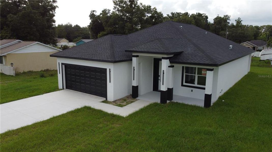 Front exterior of a new home in , Summerfield, FL, highlighting curb appeal (Image 24).