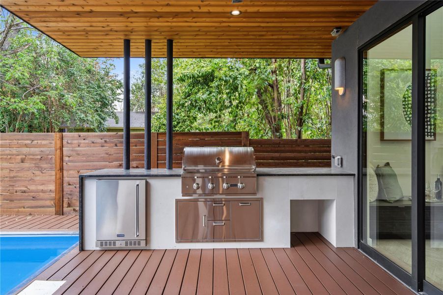 View of patio / terrace with a deck and an outdoor kitchen