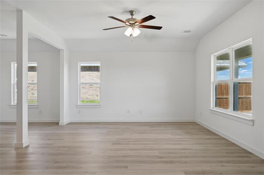 Unfurnished room featuring visible vents, light wood-type flooring, baseboards, and ceiling fan Unfurnished room featuring visible vents, light wood-type flooring, baseboards, and ceiling fan