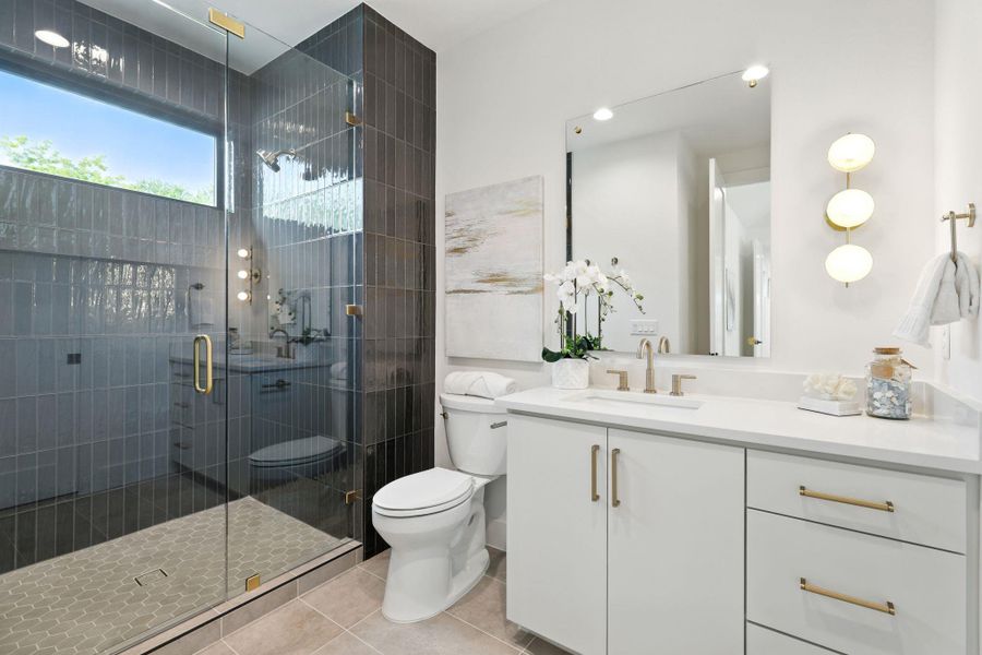 Full bathroom featuring vanity, a stall shower, and light tile patterned floors Full bathroom featuring vanity, a stall shower, and light tile patterned floors