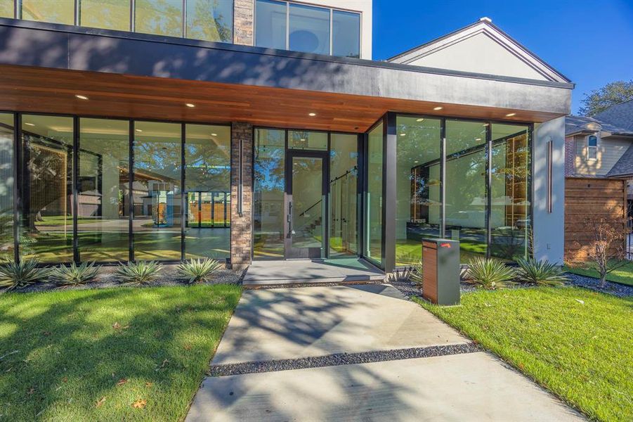 Property entrance featuring a yard and a patio Property entrance featuring a yard and a patio