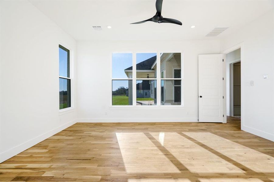 Unfurnished room with light hardwood / wood-style flooring and ceiling fan