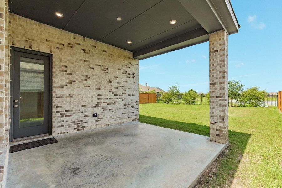 This close-up captures the rear glass door and the exterior gas line located on the column, which is conveniently positioned for grill hookup.