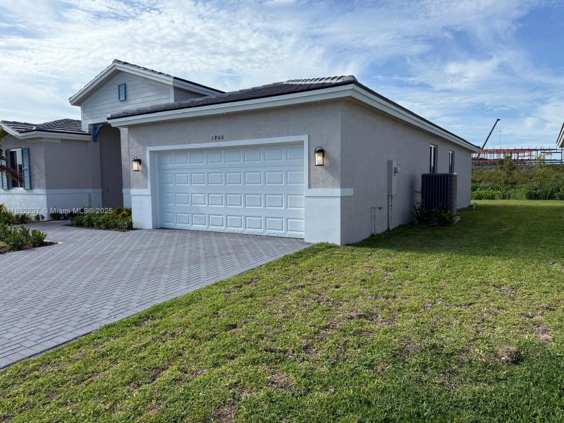 Front exterior of a new home in , Homestead, FL, highlighting curb appeal (Image 15).