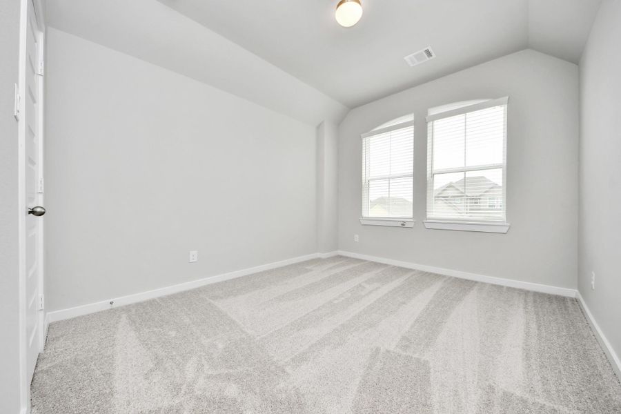 Generously sized secondary bedrooms featuring spacious closets, soft and inviting carpeting underfoot, large windows allowing plenty of natural light, and the added touch of privacy blinds for your personal retreat. Sample photo of completed home with similar floor plan. Actual colors and selections may vary.