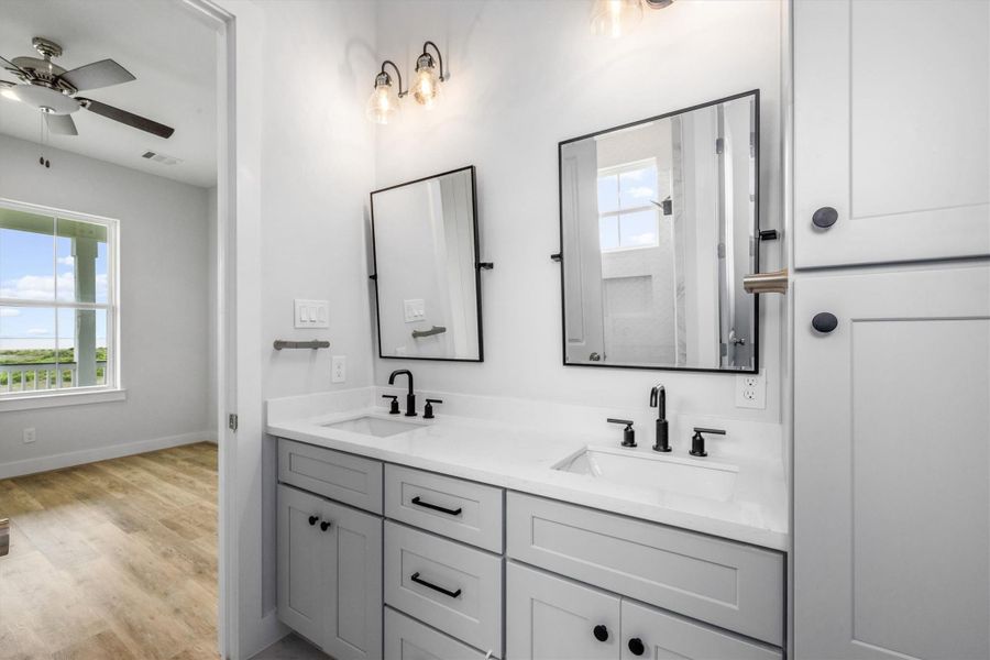 The primary bath  features a double vanity and plenty of storage.