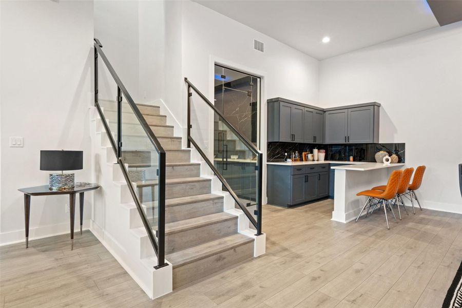 Designed for unforgettable entertaining, the lower level features a barrel-ceiling home theater, expansive game room, stylish bar, and temperature-controlled wine cellar.