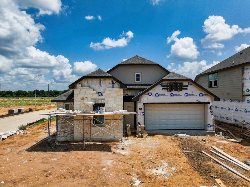 Front exterior of a new home in Oakberry Trails, Waller, TX, highlighting curb appeal (Image 1).