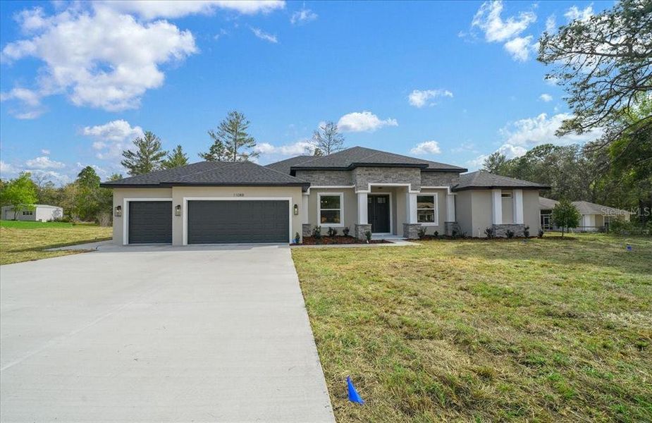 Front exterior of a new home in , Weeki Wachee, FL, highlighting curb appeal (Image 31).