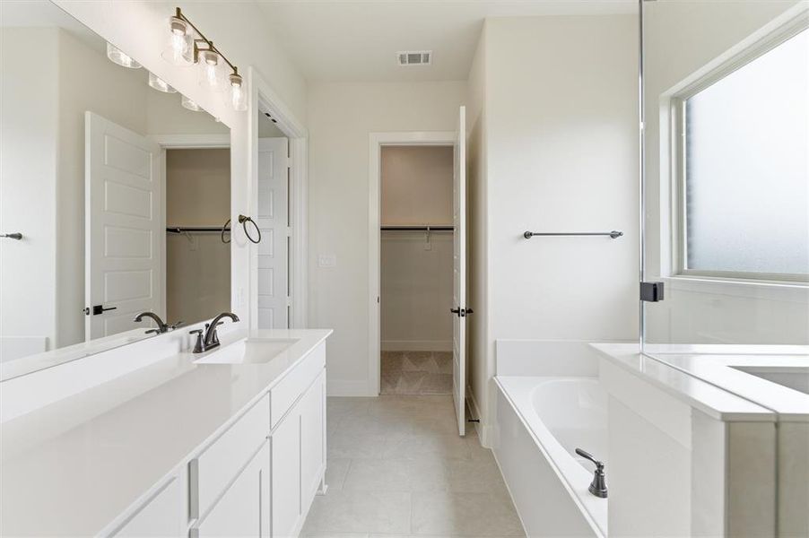 Dual vanity with white cabinetry and countertops