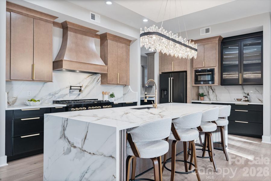 Over-sized quartz island complimented by sleek ZLINE appliances