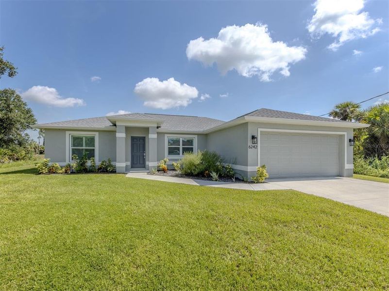 Front exterior of a new home in , North Port, FL, highlighting curb appeal (Image 1). Front exterior of a new home in , North Port, FL, highlighting curb appeal (Image 1).