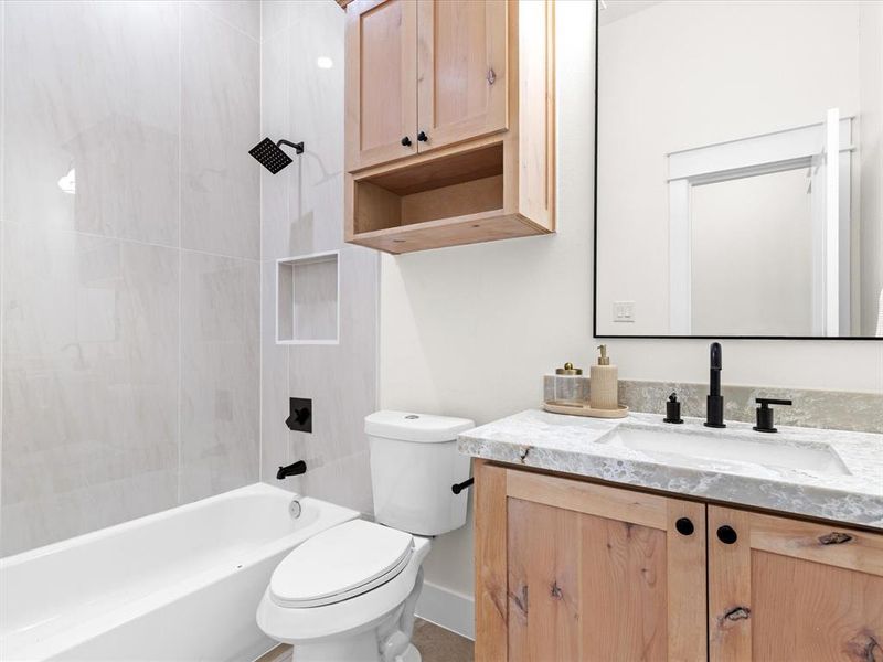 Bathroom featuring tub / shower combination and vanity
