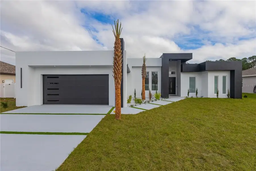 Front exterior of a new home in , Palm Coast, FL, highlighting curb appeal (Image 1). Front exterior of a new home in , Palm Coast, FL, highlighting curb appeal (Image 1).
