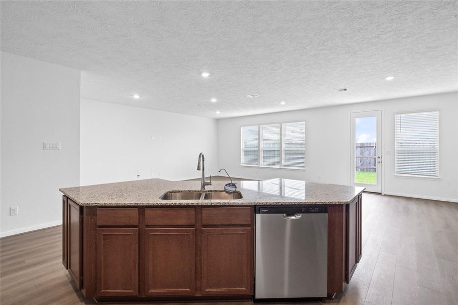 A commanding view of the open-concept design which seamlessly connects the living, dining, and kitchen areas—perfect for both everyday living and entertaining!