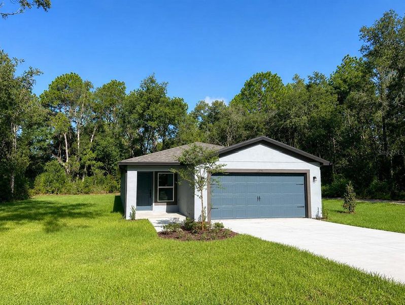 Front exterior of a new home in Royal Highlands, Weeki Wachee, FL, highlighting curb appeal (Image 2). Front exterior of a new home in Royal Highlands, Weeki Wachee, FL, highlighting curb appeal (Image 2).