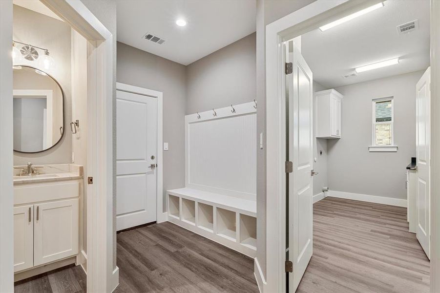 Mudroom featuring hardwood / wood-style flooring and sink Mudroom featuring hardwood / wood-style flooring and sink