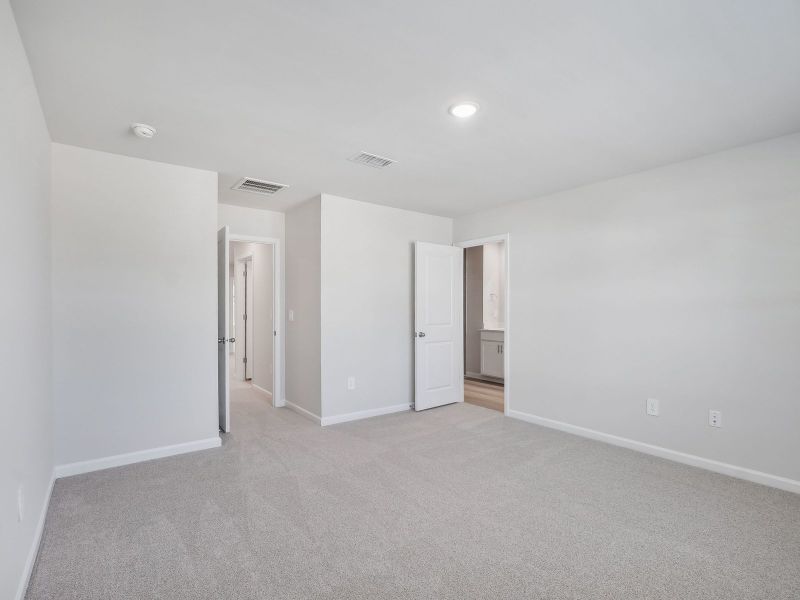 The luxurious primary suite features an ensuite bath with dual sinks and a walk-in closet.