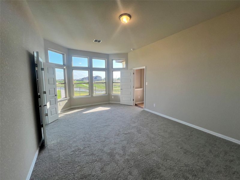 Unfurnished bedroom with carpet floors and baseboards