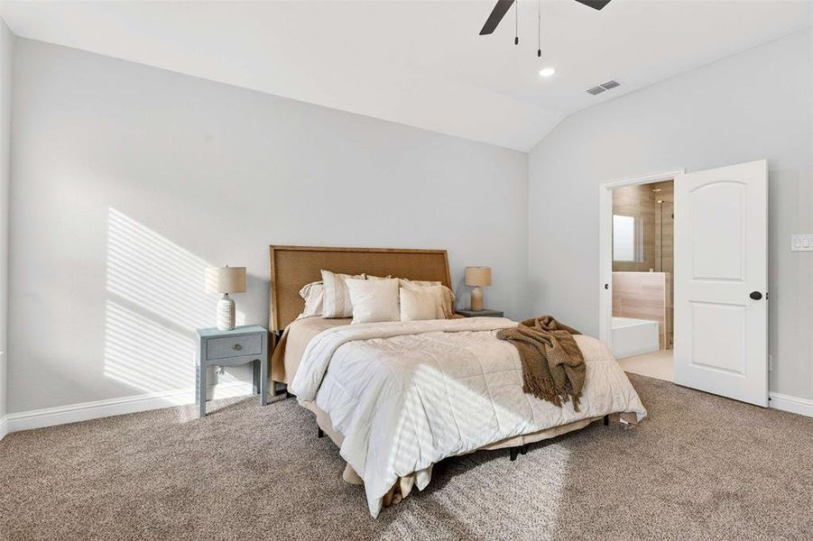Bedroom with lofted ceiling, light carpet, connected bathroom, ceiling fan, and recessed lighting