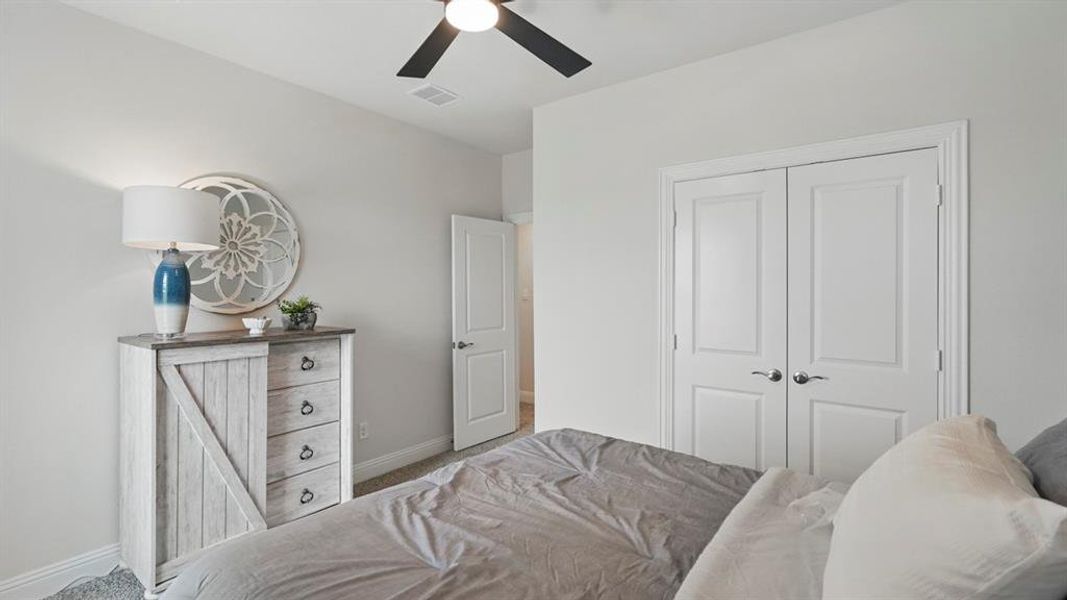 Neutral-toned room featuring a ceiling fan, light gray walls, and white trim