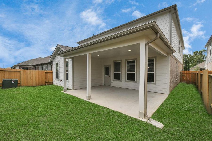 Backyard retreat, offering an abundance of space for kids to play and explore. The possibilities are endless in this outdoor haven, where the joy of open-air activities and family gatherings awaits. Sample photo of completed home with similar plan. As built color and selections may vary.