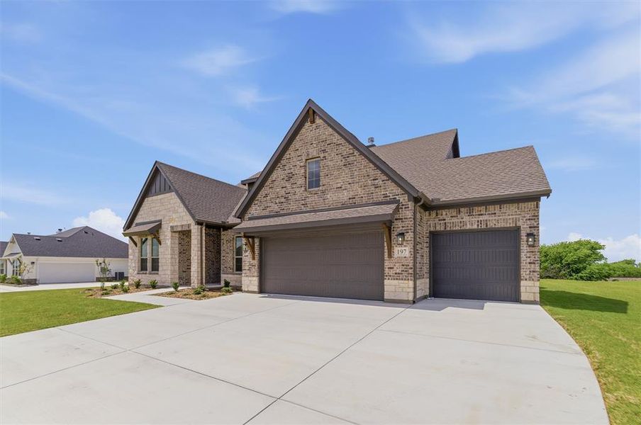 View of front of home featuring brick siding, roof with shingles, concrete driveway, an attached garage, and a front yard View of front of home featuring brick siding, roof with shingles, concrete driveway, an attached garage, and a front yard