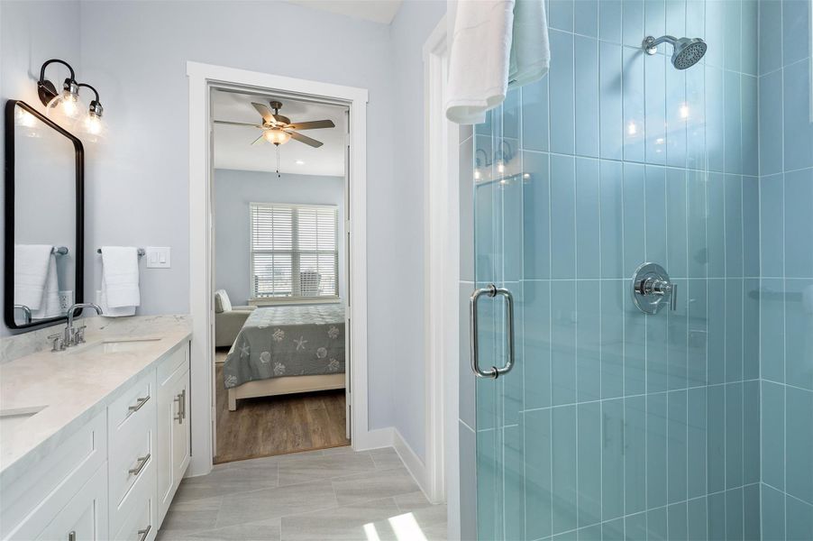 A walk-in glass shower and plenty of counter space make the Primary bath as practical as it is luxurious, delivering a true spa-at-home experience.