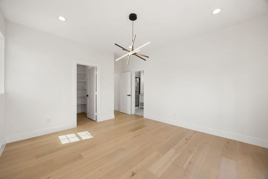 A spacious primary retreat with convenient access to a generous walk-in closet and beautifully appointed en-suite bath, ceating a private and relaxing. escape.