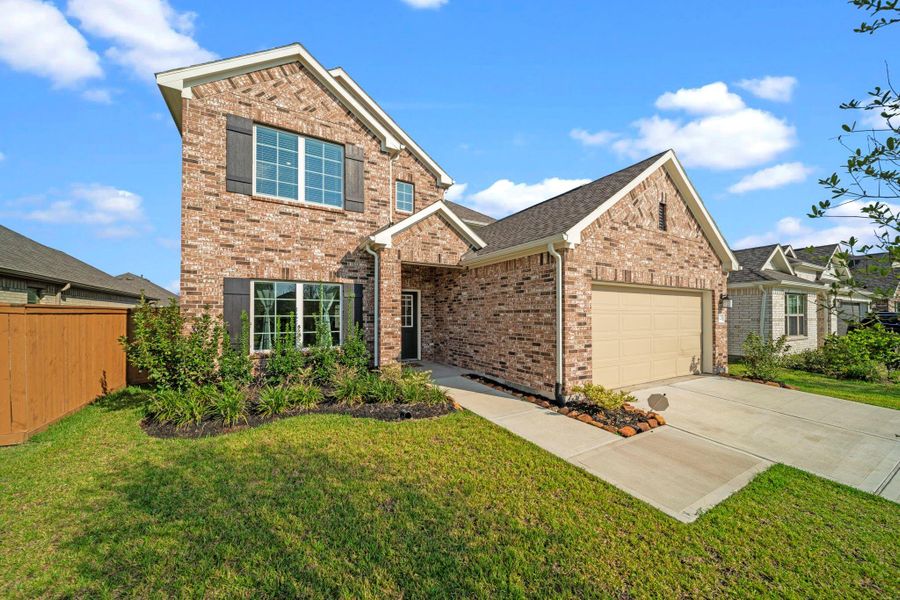 Front exterior of a new home in Marvida, Cypress, TX, highlighting curb appeal (Image 20). Front exterior of a new home in Marvida, Cypress, TX, highlighting curb appeal (Image 20).