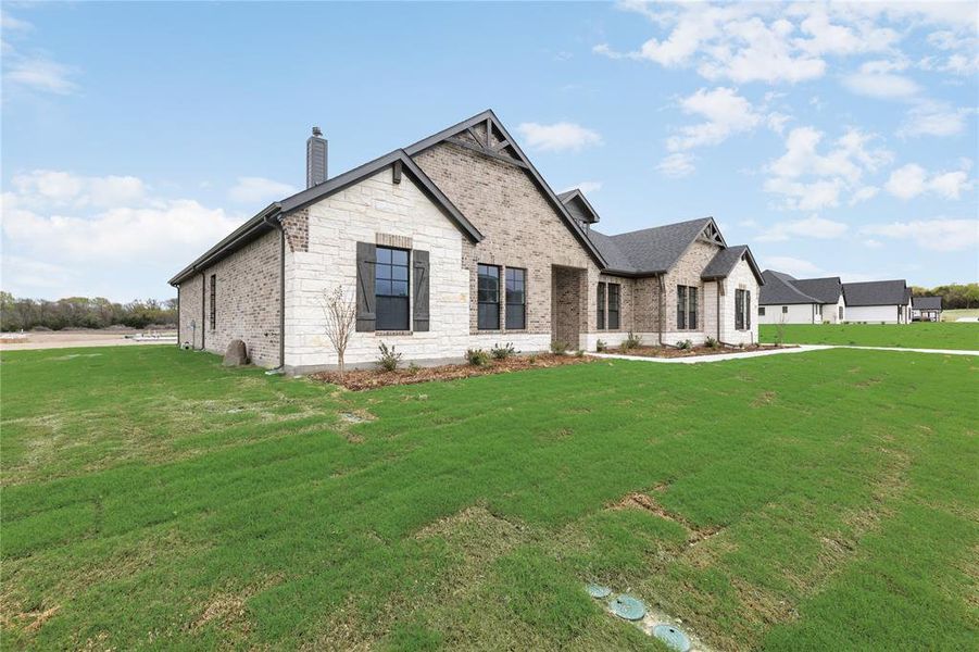 Front exterior of a new home in King Crossing Estates, Van Alstyne, TX, highlighting curb appeal (Image 2).